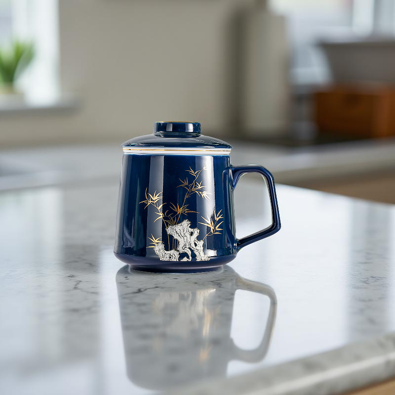 Blue ceramic mug with white animal design on a marble surface