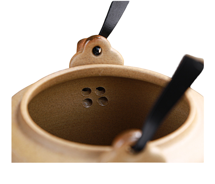 Brown ceramic incense burner with black ribbons on a white background
