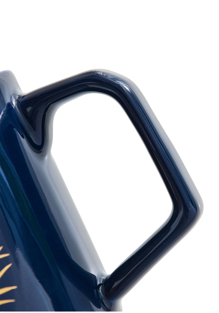 Close-up of a blue mug handle on a white background