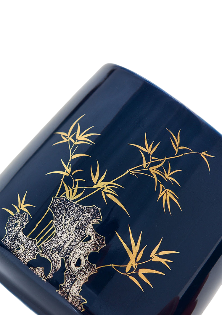 Navy blue container with gold bamboo design on a white background