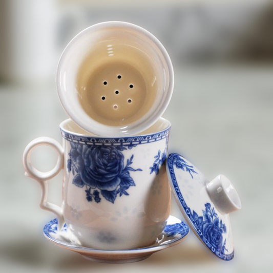 Ceramic tea cup with blue floral design and a matching saucer on a neutral background