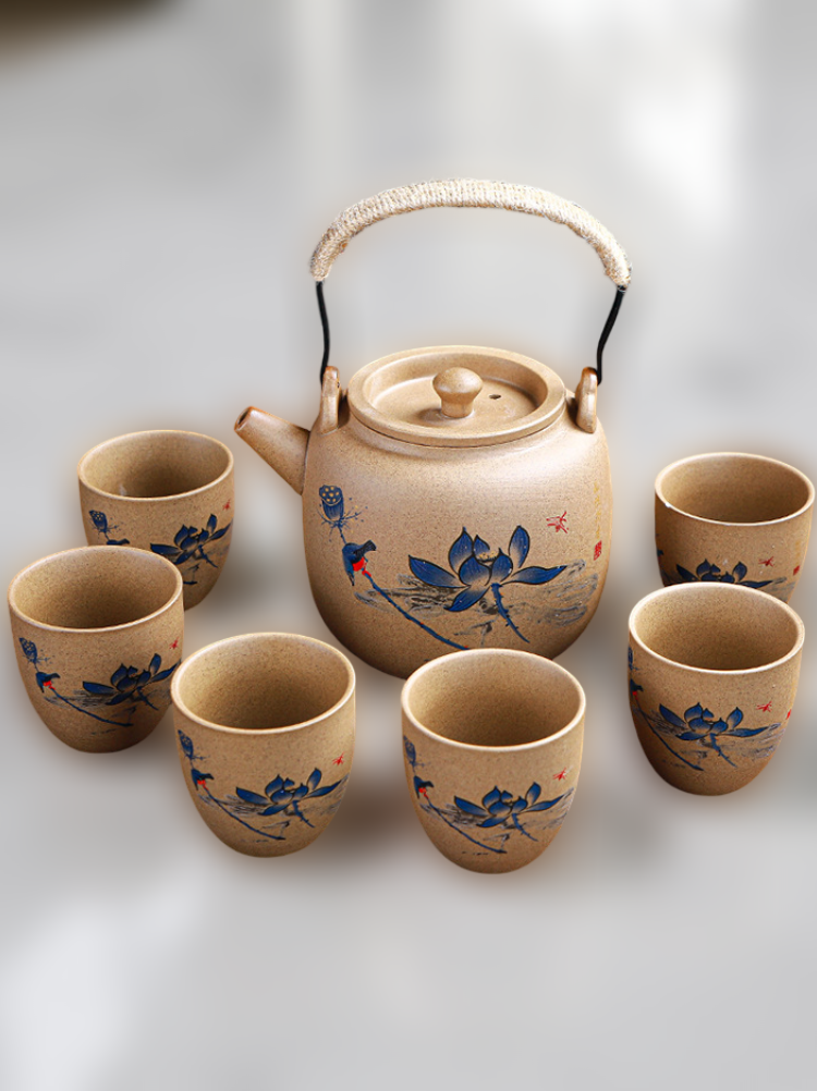 Ceramic teapot and cups with floral designs on a white background