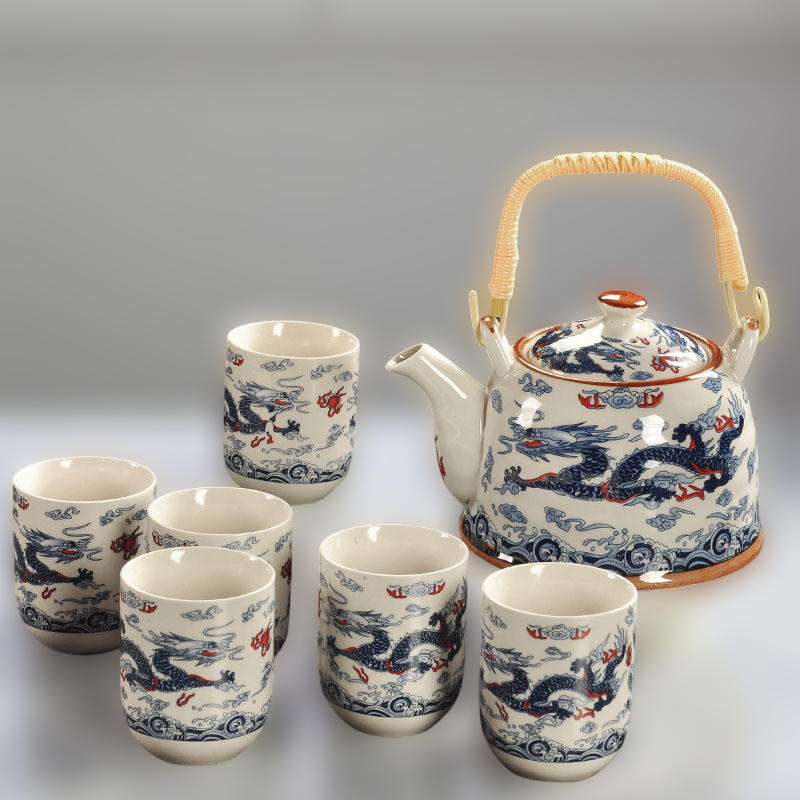 Ceramic teapot and cups with dragon design on a gray background