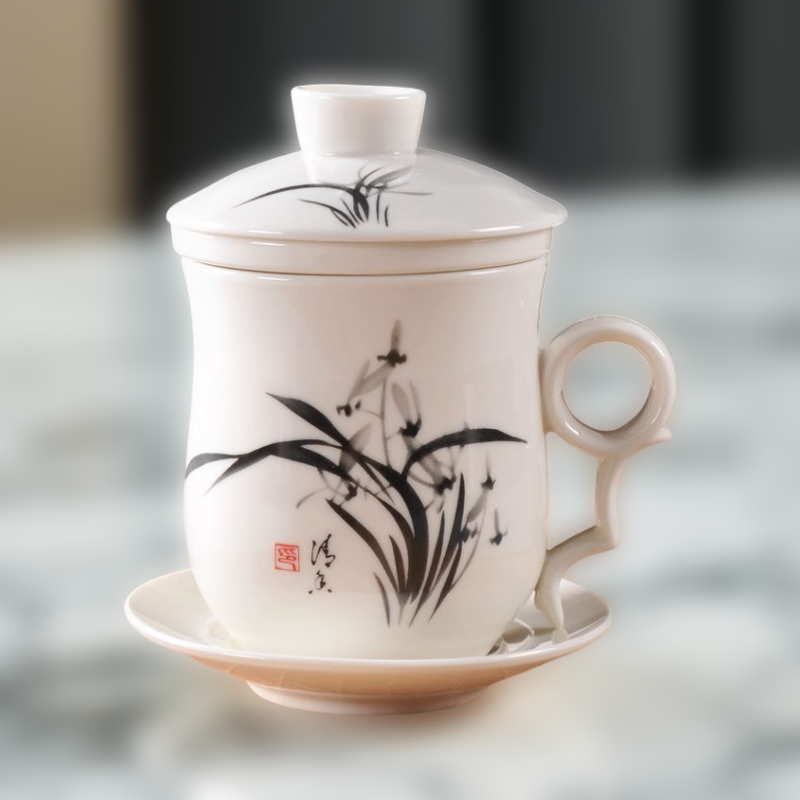 White ceramic mug with black floral design on a blurred background
