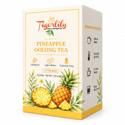 A box of Tigerlily Tea Company Pineapple Oolong Tea, featuring a cream-colored packaging design with yellow accents, watercolor illustrations of pineapples and green leaves, and brewing instructions printed on the side panel.