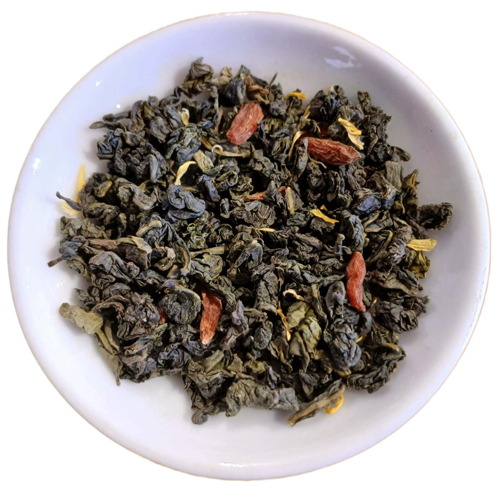 Dry tea leaves with red berries in a white bowl on a white background
