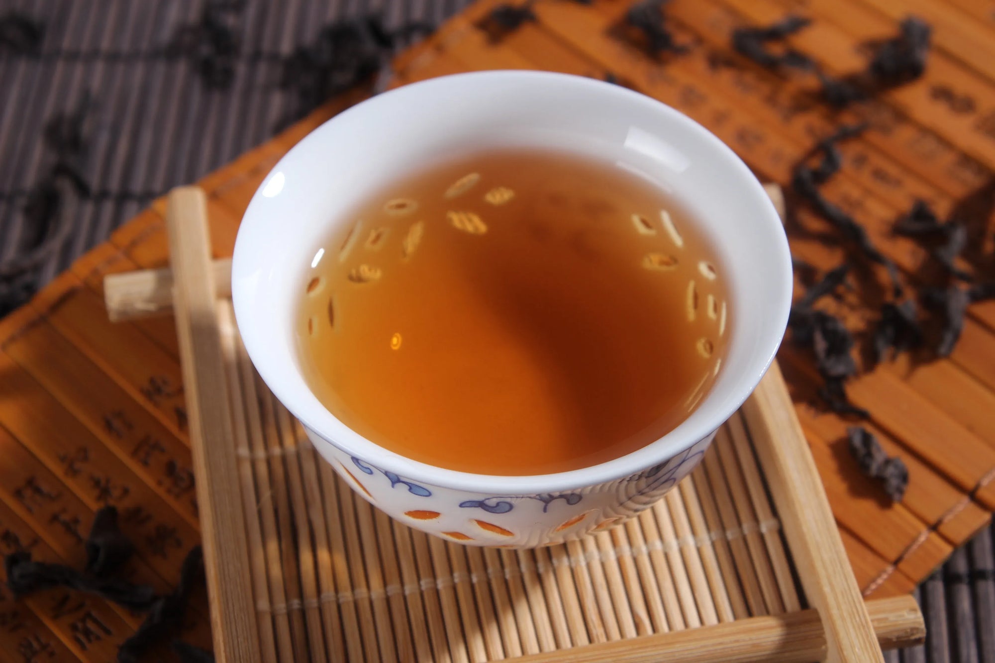 Tea cup with tea on a wooden tray